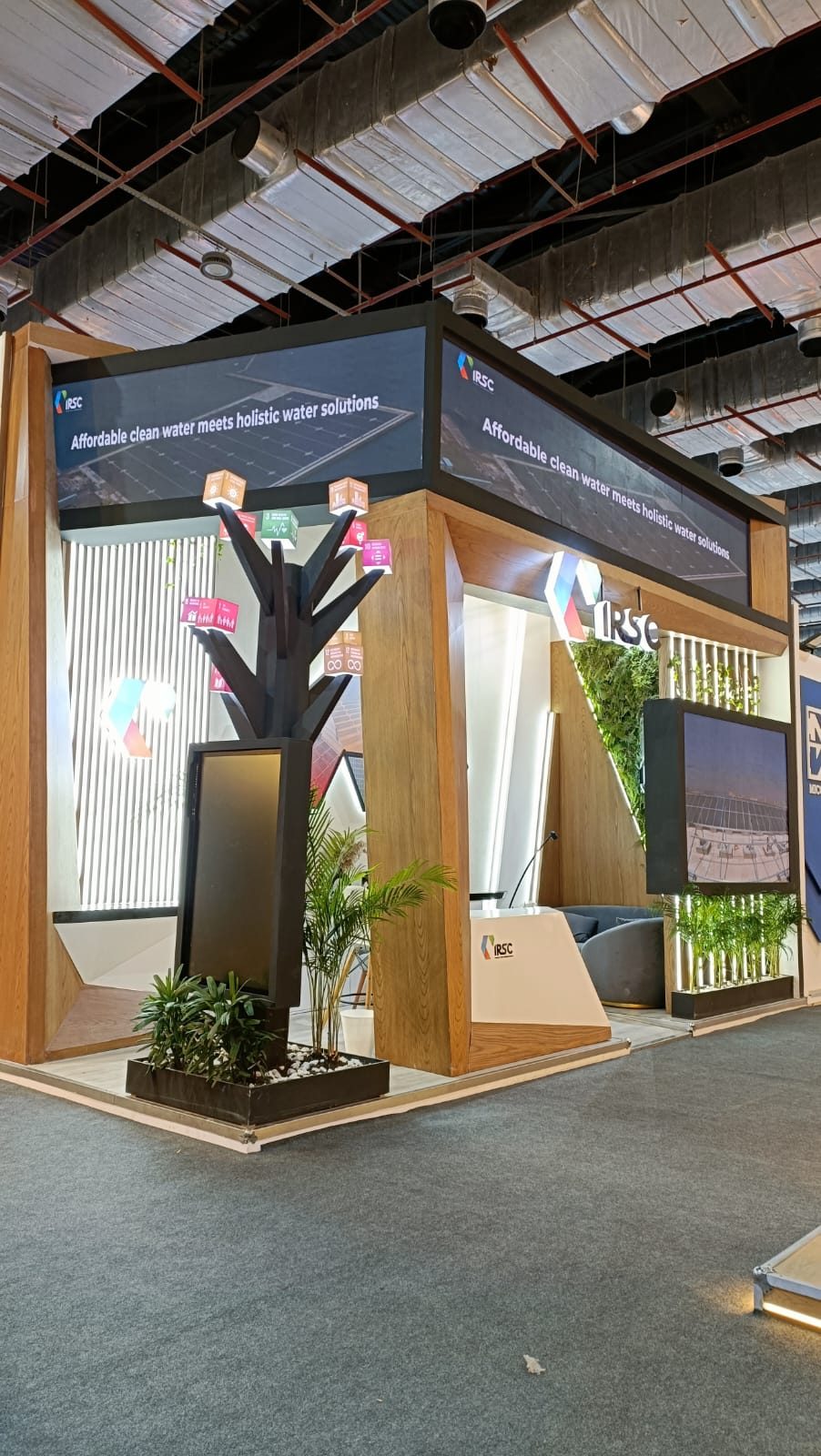 Energy company stand with feature tree and screens at EGYPES 2024
