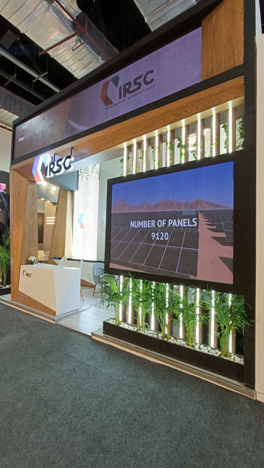 Energy exhibitor stand with LED screen and greenery at EGYPES 2024